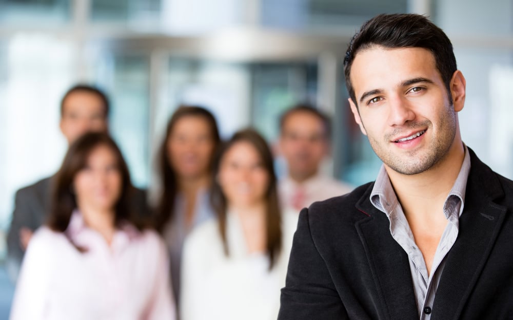 Businessman at the office with a group at the background