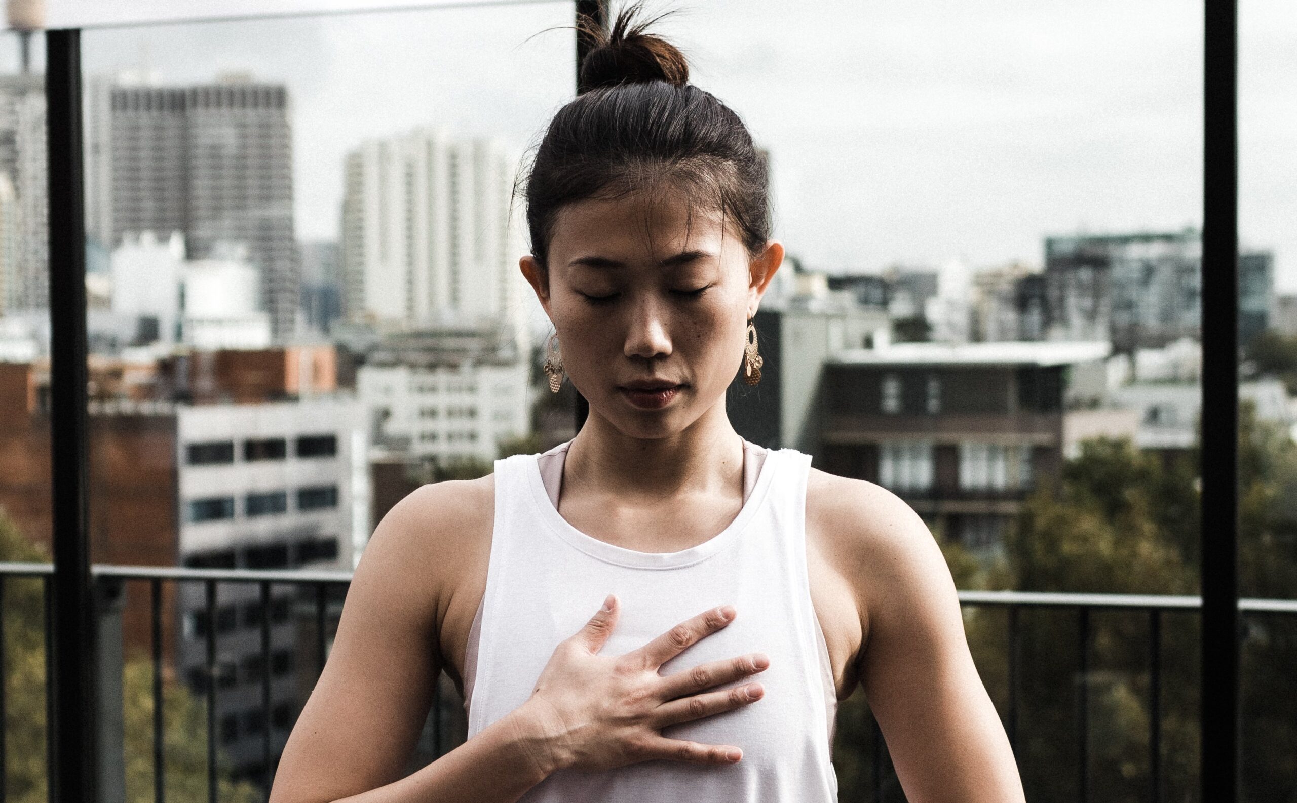 Canva - Woman doing yoga in office roof deck_