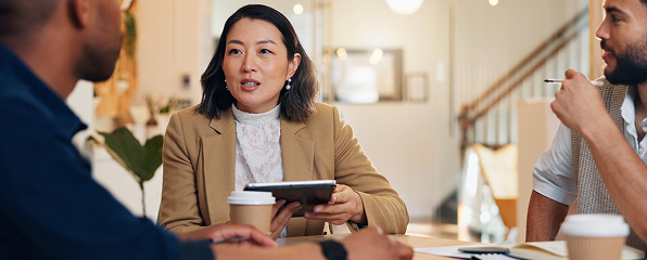A woman in discussion with her team