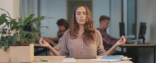 A woman meditating in the office