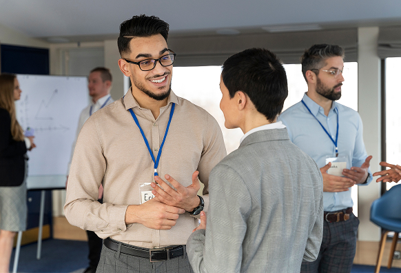 Two people networking at a conference