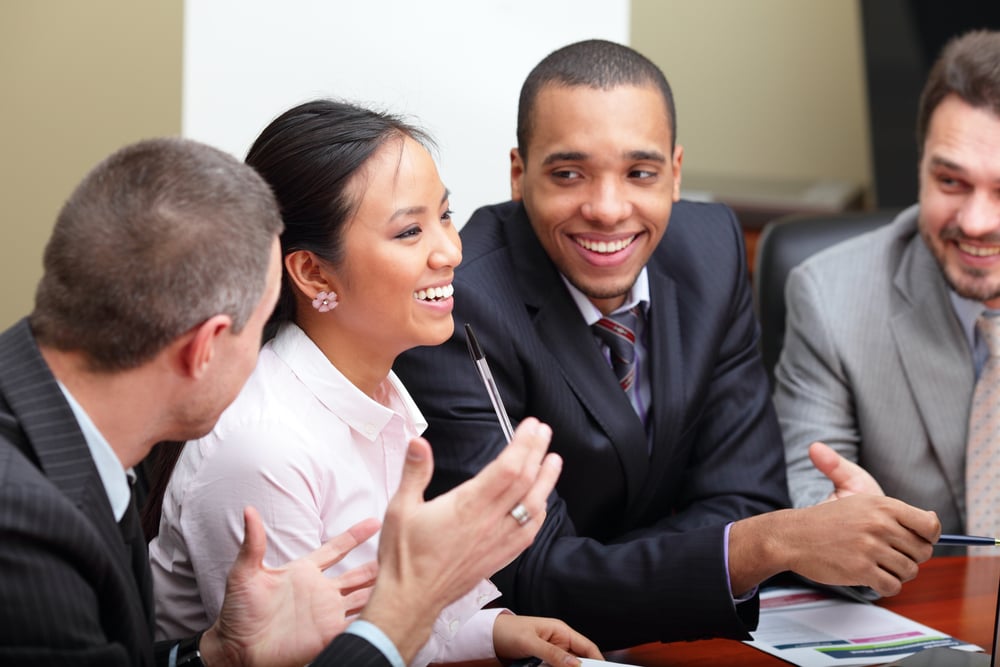 Multi ethnic business team at a meeting. Interacting. Focus on woman