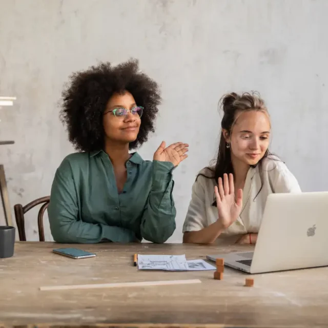 Photo of 2 people waving on an online call